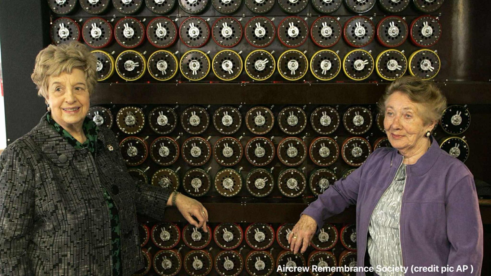 Ruth Bourne, left, and fellow veteran, Jean Valentine, stand in front of a replica Turing Bombe machine. Pic: AP