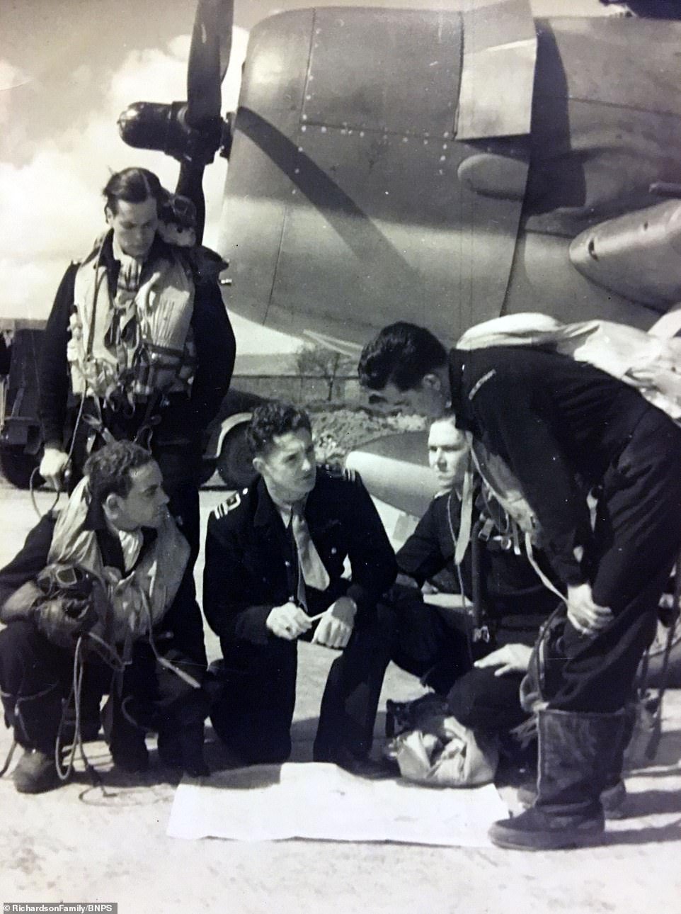 Pictured is Ron briefing fellow pilots. He travelled to Britain and joined the Royal Navy's Fleet Air Arm before training as a pilot. He spent more than three years flying Seafires and Hellcats from aircraft carriers, notably in the Mediterranean