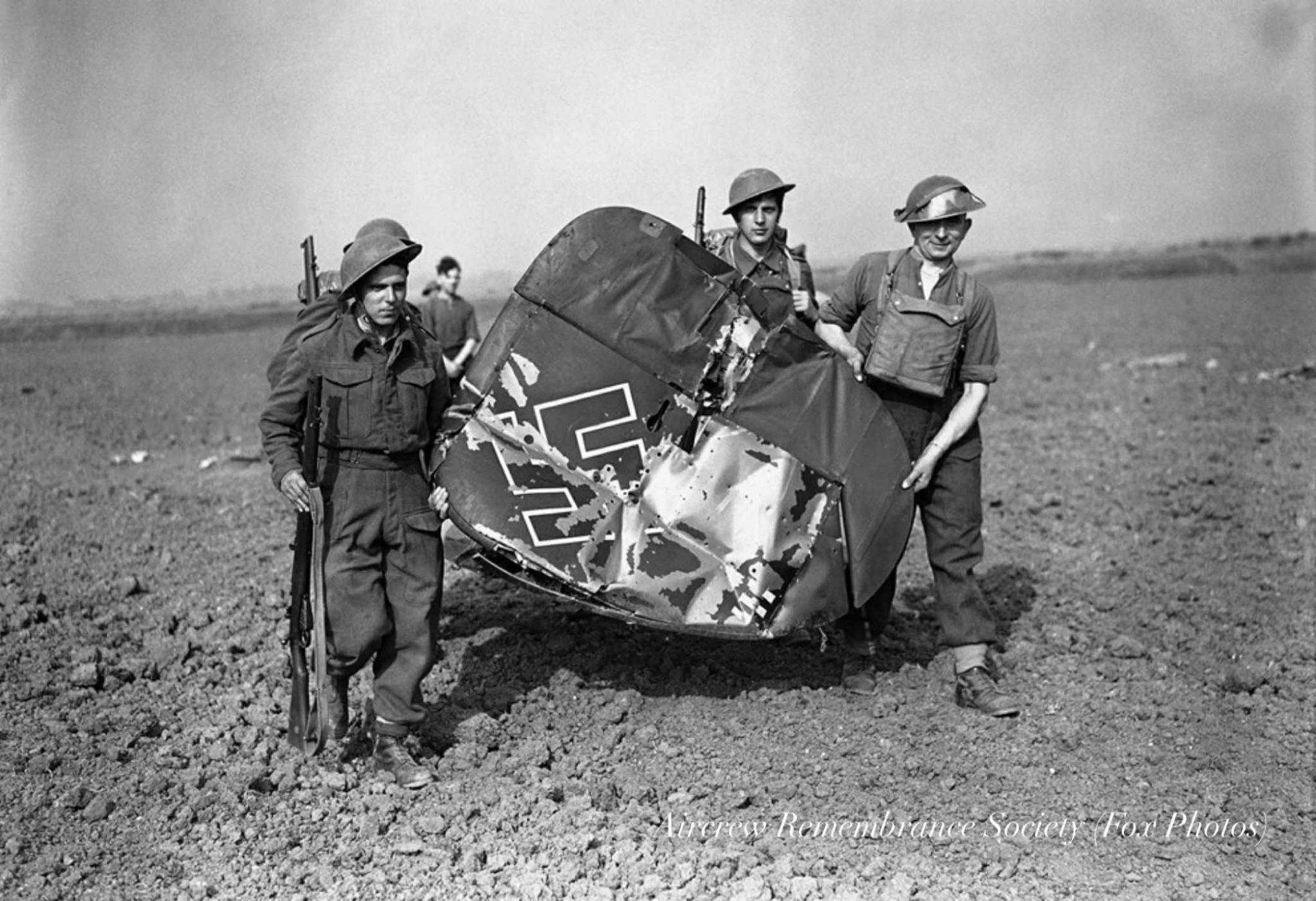 Squaddies carry the tail fin away with pride (Fox Photos) from the crash site of 3./ZG2 Messerschmitt Bf 110C-4 Wnr.3113 Ofw. Winkler