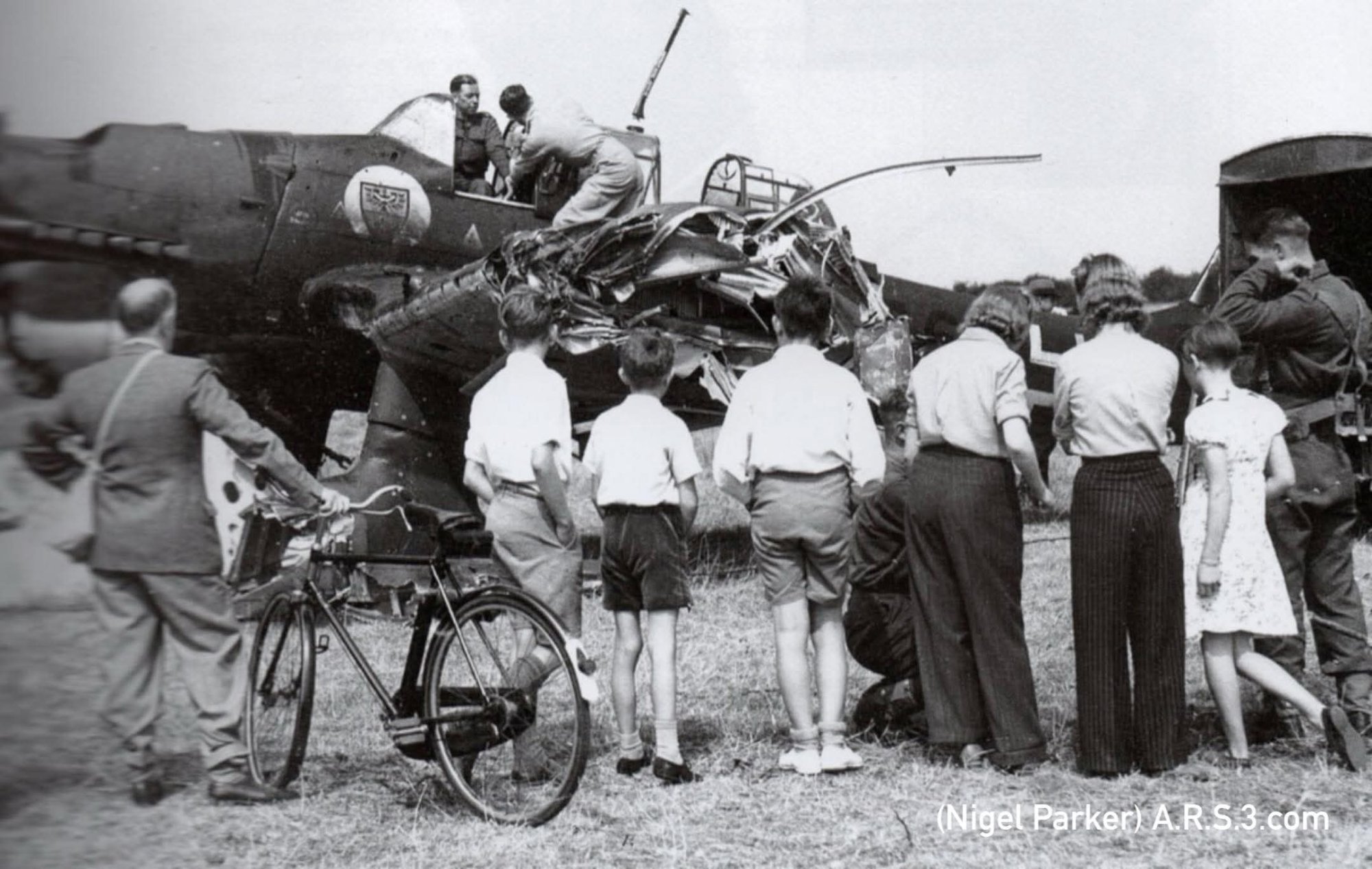 The aircraft being inspected by RAF personnel and viewed by the public. (Parker).