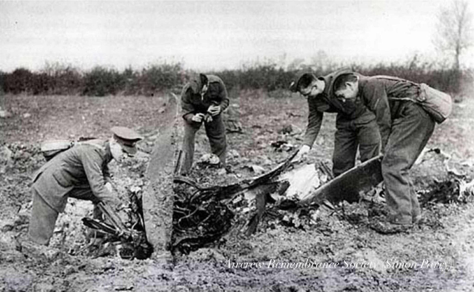 Wreckage of the Ju 88 being examined in the field and in the gulley at the edge of the field (Parry) Red Kite.
