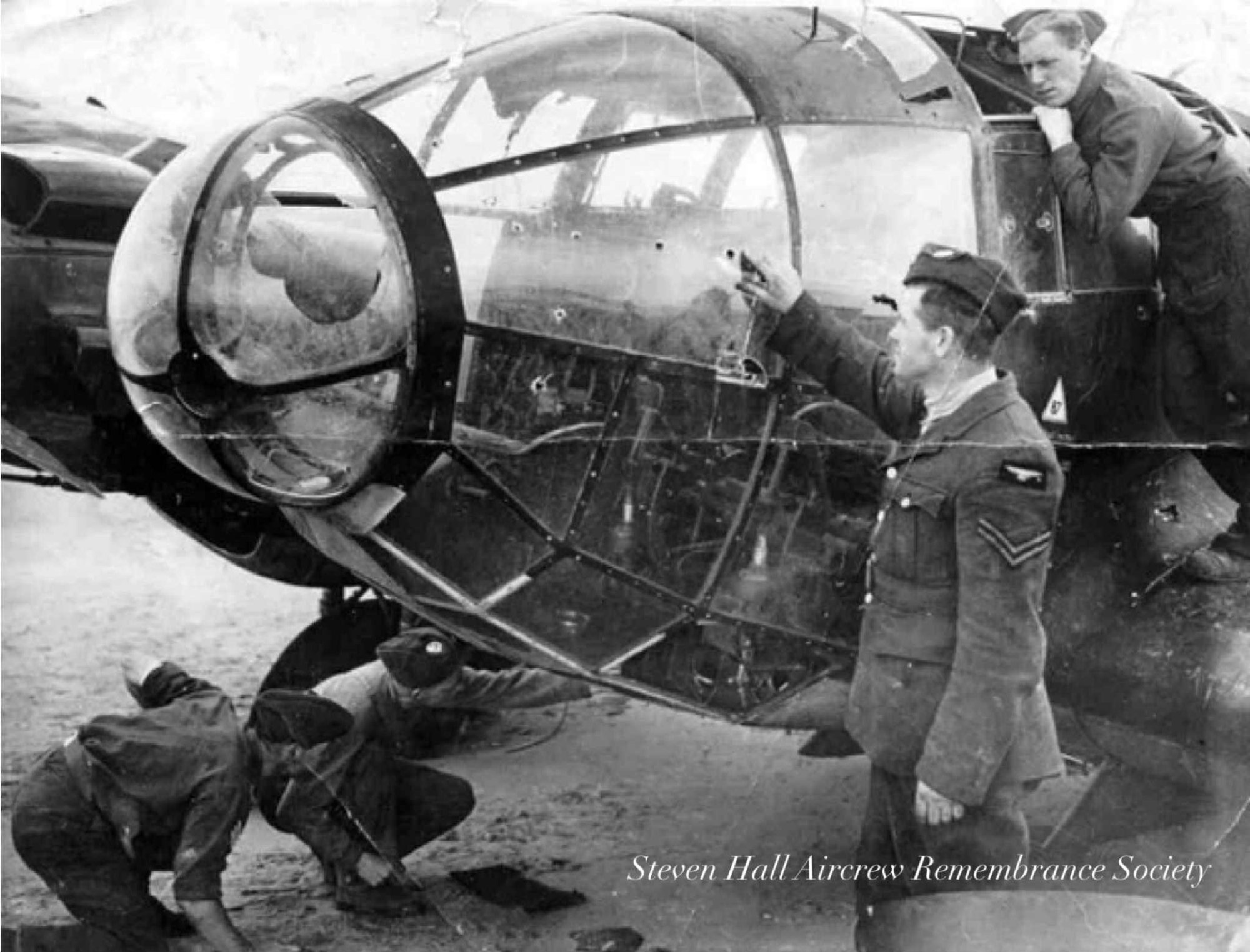R.A.F. personnel examine the bullet strikes in the cockpit area of Metzger’s Heinkel (Steven Hall)
