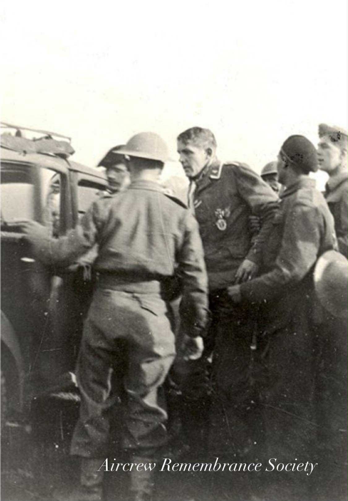 The pilot Rudolf Schumann being taken away. (2./KG77 Junkers Ju 88A-1 Wnr.8095)