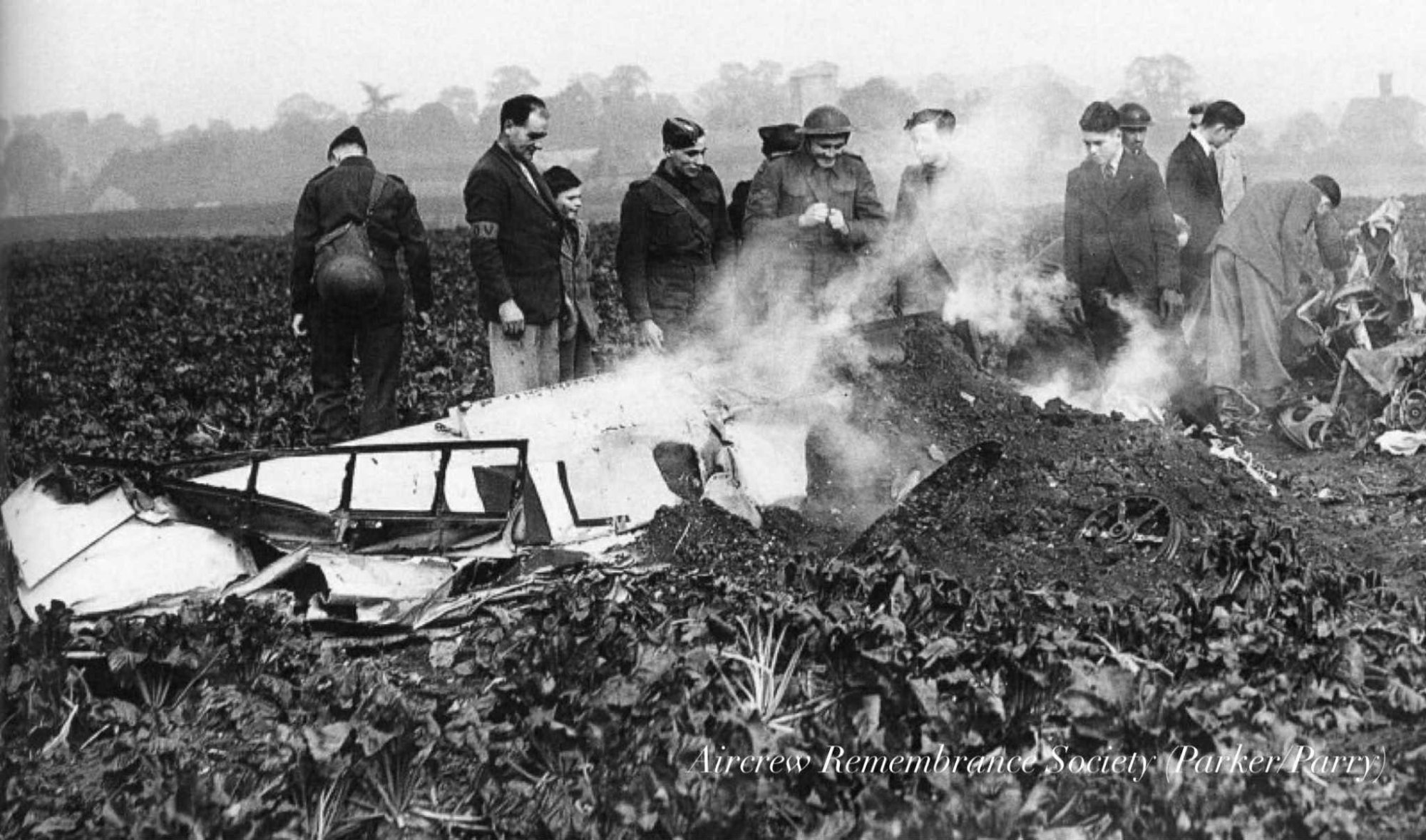 The wings were the only thing left smoking on the surface after it dived into the ground. A main wheel and tyre, propeller blade can also be seen. (Parker/Parry).
