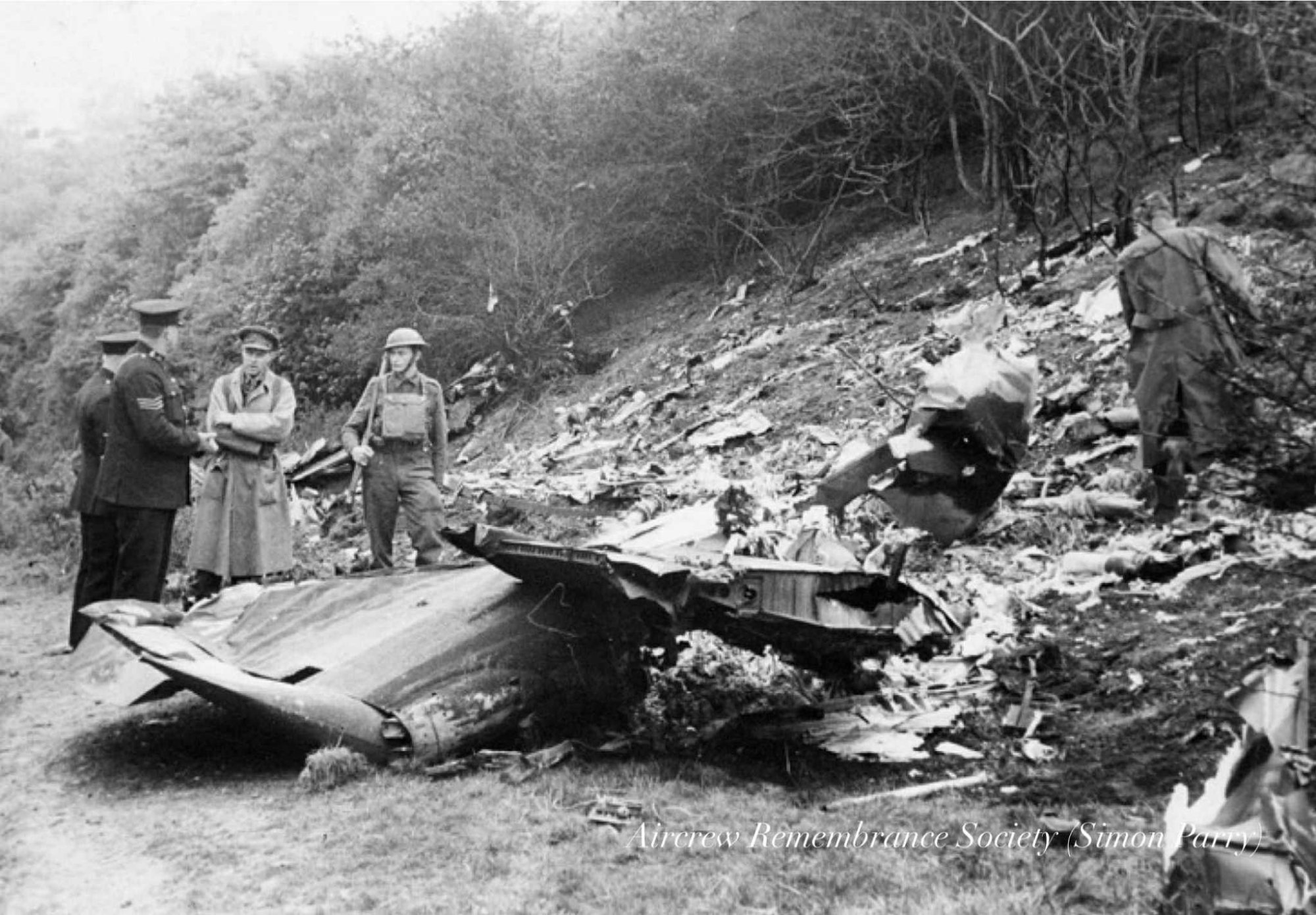 Army or Home Guard officers together with the police survey the disintegrated Junkers 88 at Poynings. (via Parry)