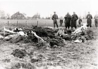 Soldiers peer into the hole made by the high speed crash of Lt. Ottmer's Bf 109E