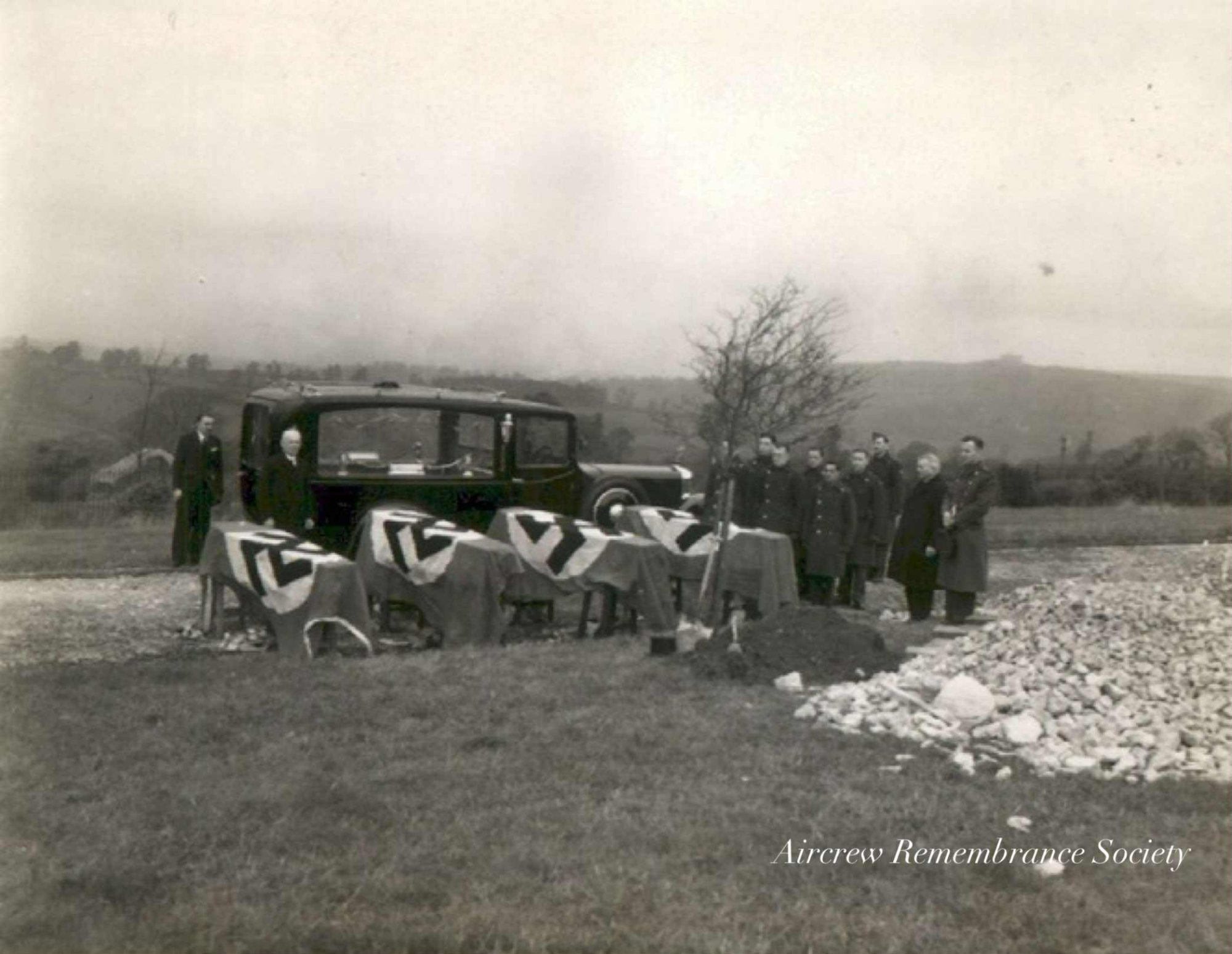 The crew with their flag draped coffins prior to burial.