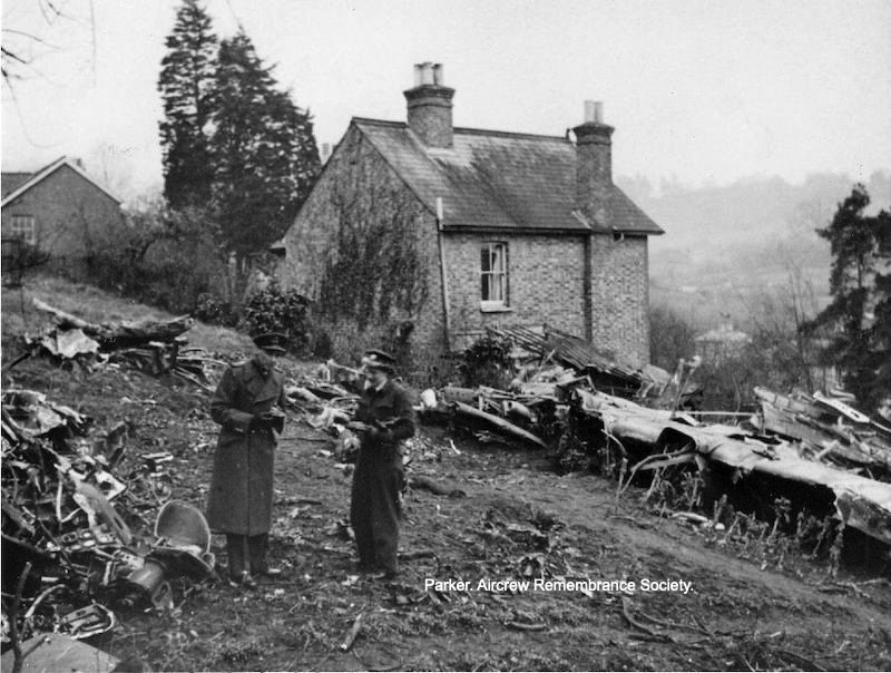 A photo of the crash site showing Richard Raspin collecting souvenirs.
