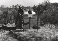 Memorial on the graves at the crash site erected by the Luftwaffe.At the time of the crash the Luftwaffe were only able to identify oneof the crew, Sgt. McKinley, his name is inscribed on the cross along with 3 unknown. The memorial also includes one of the fins and rudders from P4286, along with other items of wreckage, note also the flying helmet on top of the cross. (All photo's courtesy Jan Jolie)