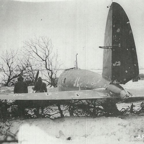 A view looking from the tail of the aircraft, the fuselage riddled with bullets