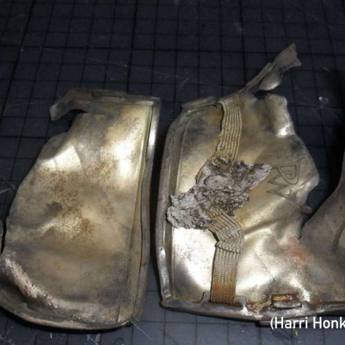 Found in 2008 between rocks at the crash site by Harri Honkanen, remains of one cigarette can be seen inside the case.
