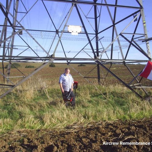 David King erects the flags of remembrance near to the crash site (Brownless)