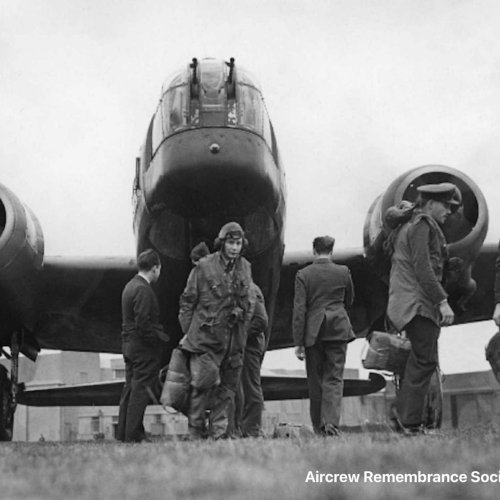 With ground crews already running up the engines of their Wellington, crew members pose for the camera before boarding their aircraft for a mission. (I.W.M.)