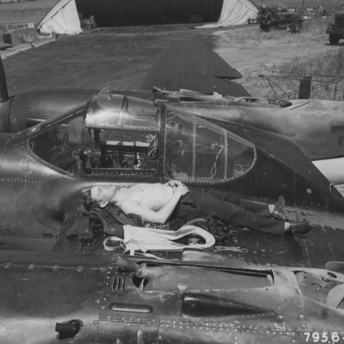 Lt O' Bannon sun bathing on the wing of his F5 at Mount Farm.